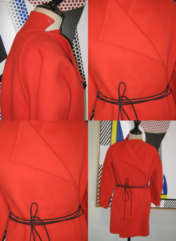 Geoffrey Beene red wool coat showing repeating motifs: tied belting and triangle slashed shapes.