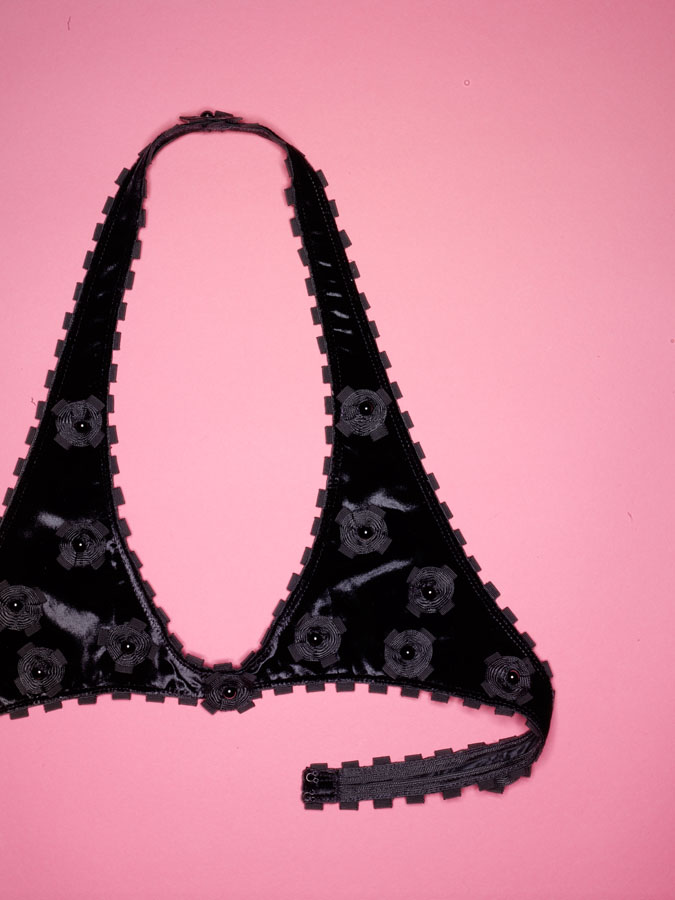 Geoffrey Beene black velvet halter with flower appliqué.